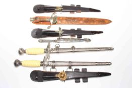 Collection of seven replica and other daggers.