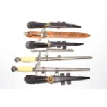 Collection of seven replica and other daggers.