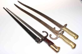 Three French 19th Century bayonets, one with scabbard.