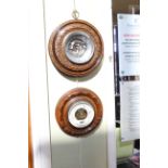 Two walnut framed circular barometers.