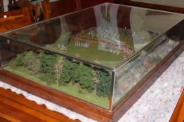 A cased military model of a battle, 102cm by 62cm by 25cm.