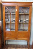 Edwardian painted satinwood two door vitrine on square tapering legs to spade feet, 168cm by 99cm.