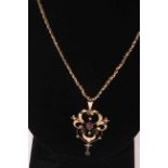 1920's 9 carat gold, ruby and seed pearl pendant and chain.