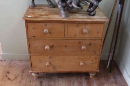 Pine chest of two short above two long drawers on turned legs, 80cm by 83cm.