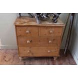 Pine chest of two short above two long drawers on turned legs, 80cm by 83cm.