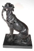 Bronze sculpture of working dog with stick on marble plinth.