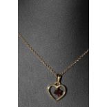 9 carat gold and garnet set heart shaped pendant and chain.