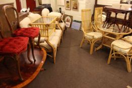 Cane conservatory furniture comprising two seater settee, chair and footstool,