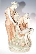 Large porcelain group of male and female water carriers in the style of Royal Dux, 57cm high.