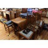 Oak gate leg dining table and six rail back chairs including pair carvers.