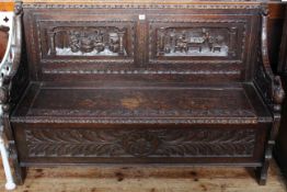 Victorian carved oak box settle, 87cm by 137cm.