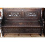 Victorian carved oak box settle, 87cm by 137cm.