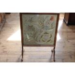 Walnut framed glazed needlework panel firescreen, 87.5cm by 62.5cm.