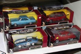 Ten boxed die-cast toy cars by Deluxe Die-cast Metal Collection.