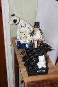 Eight cast iron figures including Michelin, Mr Peanut, dogs, money box.