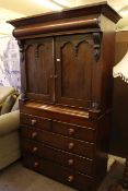 Victorian linen press having two panelled doors above two short and three long drawers.