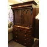 Victorian linen press having two panelled doors above two short and three long drawers.