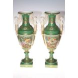 Pair of urn shaped vases with winged maiden handles, decorated with floral panels,