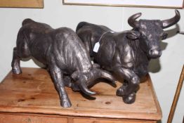 Pair of composite model bulls, 64cm and 57cm.