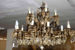 Fifteen branch gilt metal two tier chandelier with crystal glass drops.