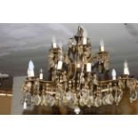 Fifteen branch gilt metal two tier chandelier with crystal glass drops.