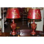Good pair of chinoiserie table lamps with shades, the urn shade bodies decorated with figures,