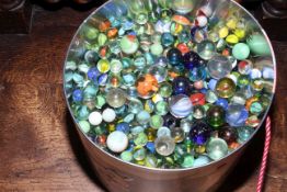 Tin of marbles.