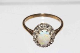 Opal and twelve stone diamond ring set in 9 carat gold, size N.