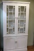 Painted four door cabinet bookcase, 202cm by 103cm.