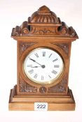 Late Victorian carved walnut cased mantel clock, 24cm.