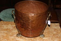 19th Century copper jardiniere with twin brass handles raised on three brass paw feet.