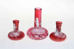 Garniture of three Victorian ruby glass Mary Gregory vases.