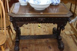 Victorian carved oak centre table having canted corners and frieze drawer raised on turned supports,