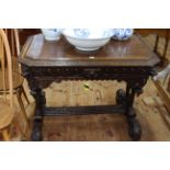 Victorian carved oak centre table having canted corners and frieze drawer raised on turned supports,