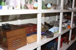 Large shelf collection of linens, collectors plates, glass, ceramics, metalwares, LP records,