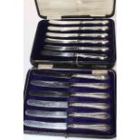 Two cased sets of silver handled tea knives.