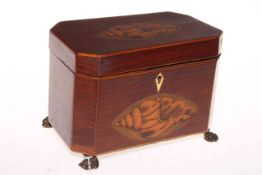 Shell inlaid mahogany tea caddy on brass paw feet.