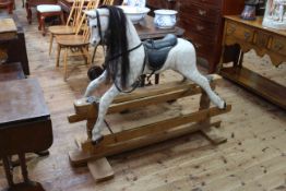 Dapple grey rocking horse on pine safety stand, 110cm by 133cm.