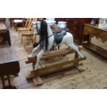 Dapple grey rocking horse on pine safety stand, 110cm by 133cm.