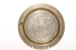 Islamic brass dish with silver inlay, 19.5cm diameter.