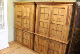 Pair Mexican pine four door cabinets fitted with shelves, 188cm by 125cm.