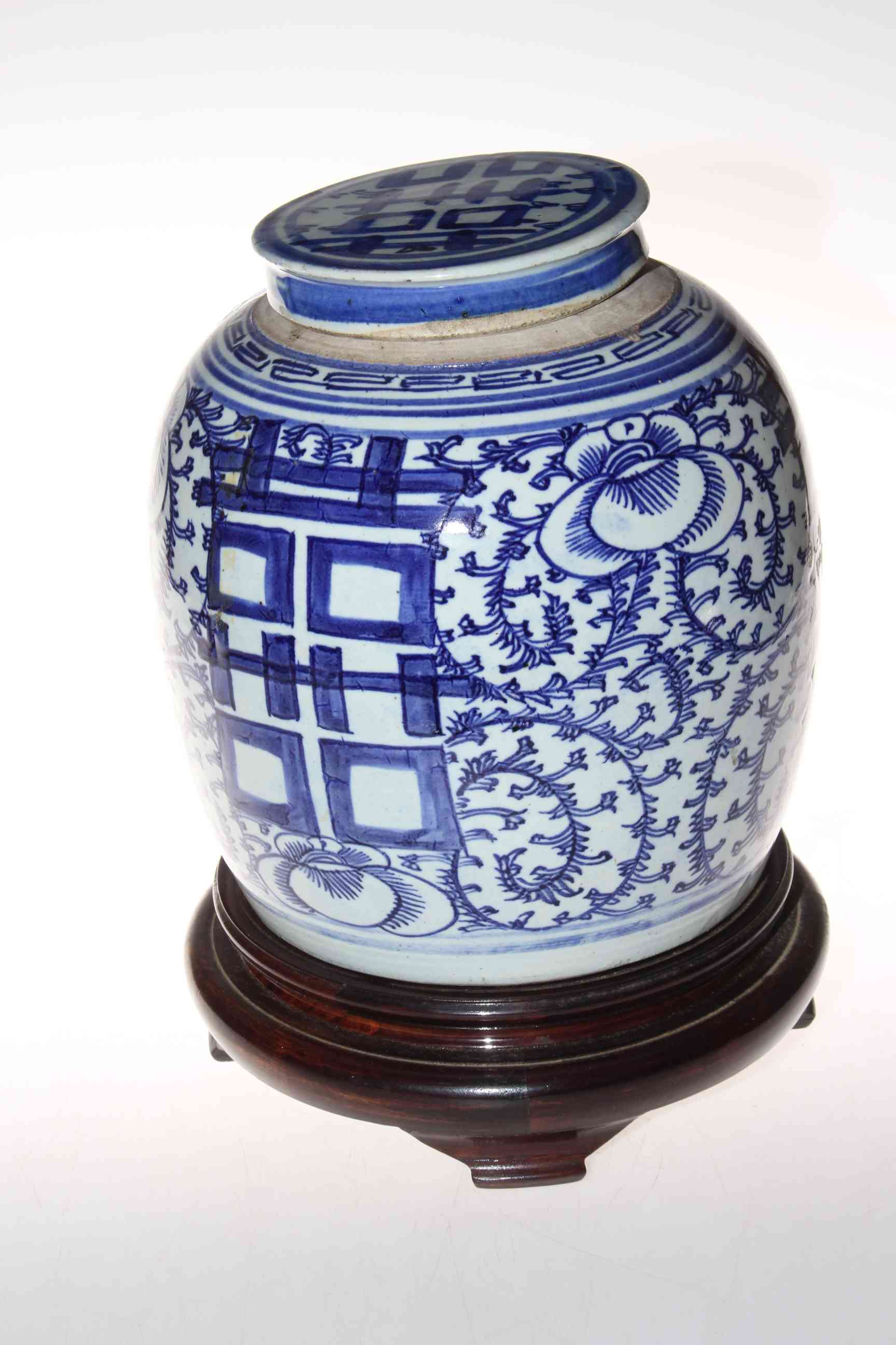 Oriental blue and white ginger jar on wooden stand, 30cm.