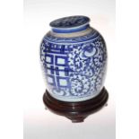 Oriental blue and white ginger jar on wooden stand, 30cm.