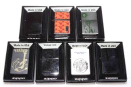 Seven boxed Zippo lighters.