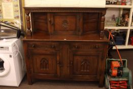 Oak buffet sideboard with carved rose panel door.