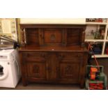 Oak buffet sideboard with carved rose panel door.