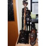 Two tribal masks, two pairs of tribal busts, two figures, stick and shield (9).