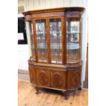 Edwardian mahogany cabinet having two glazed doors above two cupboard doors with bowed sides and on