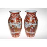 Pair large Japanese vases painted with scene of three figures on terrace and profuse foliage,
