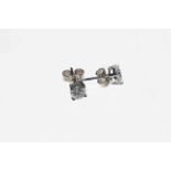 Pair of diamond stud earrings claw set in 18 carat white gold, approximate diamond content 0.